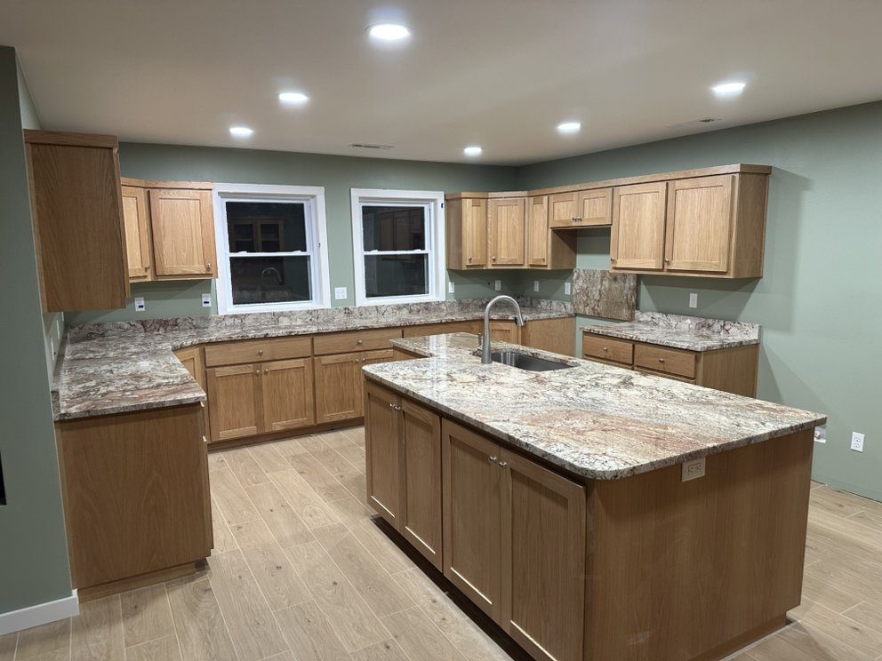 Granite countertops in warm gold and rust tones — a real Precision Granite & Marble project near Rogers, AR.